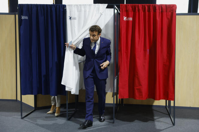French President and centrist candidate for reelection Emmanuel Macron exits the voting booth at a polling station in Le Touquet, northern France, Sunday, April 24, 2022. 
