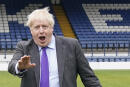 Britain's Prime Minister Boris Johnson reacts during a visit to the football club Bury FC at their ground in Gigg Lane, Bury, Greater Manchester, on April 25, 2022. (Photo by Danny Lawson / POOL / AFP)