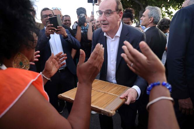 Prime Minister Jean Castex plays kayamb in St. Pierre on Reunion Island on April 14, 2022, while campaigning for Emmanuel Macron.