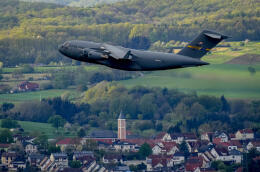 A C-17 Globemaster military aircraft takes off from Ramstein military airbase, and flies over Ramstein-Miesenbach, Germany, Tuesday, April 26, 2022. (AP Photo/Michael Probst)