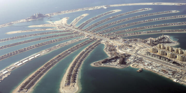 FILE - In this May 3, 2007 file photo, Jumeira Palm Island is seen from a helicopter. A new report released Tuesday, June 12, 2018, by the Washington-based Center for Advanced Defense Studies, described Dubai's real-estate market as a haven for money launderers, terror financiers and drug traffickers sanctioned by the U.S. in recent years. The properties in question include million-dollar villas on the fronds of the man-made Palm Jumeirah archipelago to one-bedroom apartments in more-affordable neighborhoods in Dubai, the UAE's biggest city. (AP Photo/Kamran Jebreili, File)