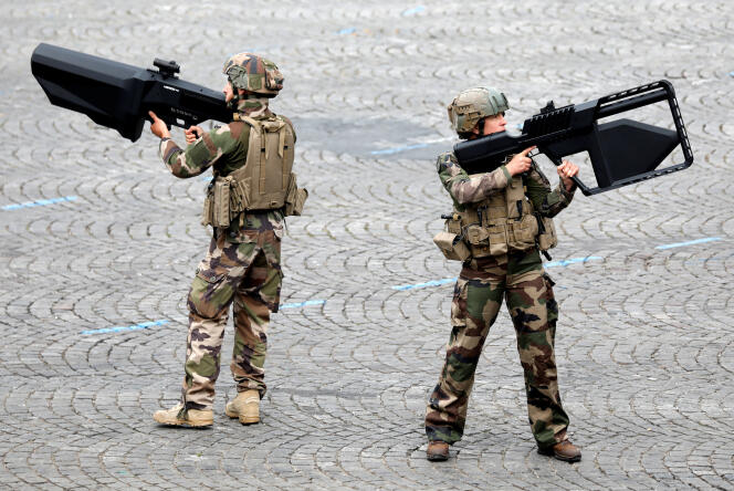 French soldiers hold anti-drone guns during the traditional Bastille Day military parade on the Champs-Elysees Avenue in Paris