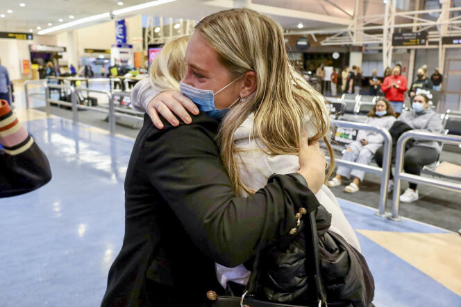 Families hug after a flight from Los Angeles arrived at Auckland International Airport as the New Zealand border opened for visa-free countries, May 2, 2022.