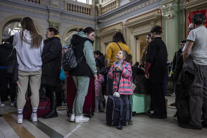 Ukrainian refugees wait at the train station in Przemysl, eastern Poland on April 7, 2022.