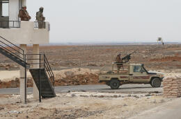 A picture taken during a tour origanized by the Jordanian Army shows soldiers patrolling along the border with Syria to prevent trafficking, on February 17, 2022. - Drug trafficking from Syria into Jordan is becoming "organised" with smugglers stepping up operations and using sophisticated equipment including drones, Jordan's army said, warning of a shoot-to-kill policy. Since the beginning of this year, Jordan's army has killed 30 smugglers and foiled attempts to smuggle into the kingdom from Syria 16 million Captagon pills -- more than they seized in the whole of 2021 -- the military said. (Photo by Khalil MAZRAAWI / AFP)