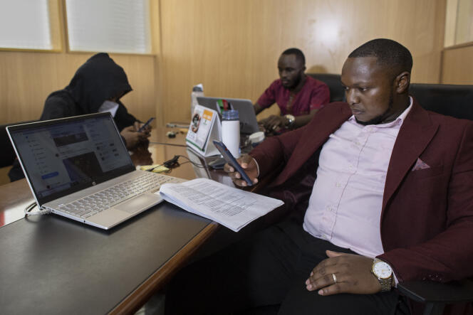 Ian James Mwai (right) is a social media influencer who offers his services to candidates in a bid to influence the August 9 presidential election. Here, in an office in the town of Thika, northeast of Nairobi, on April 26, 2022.