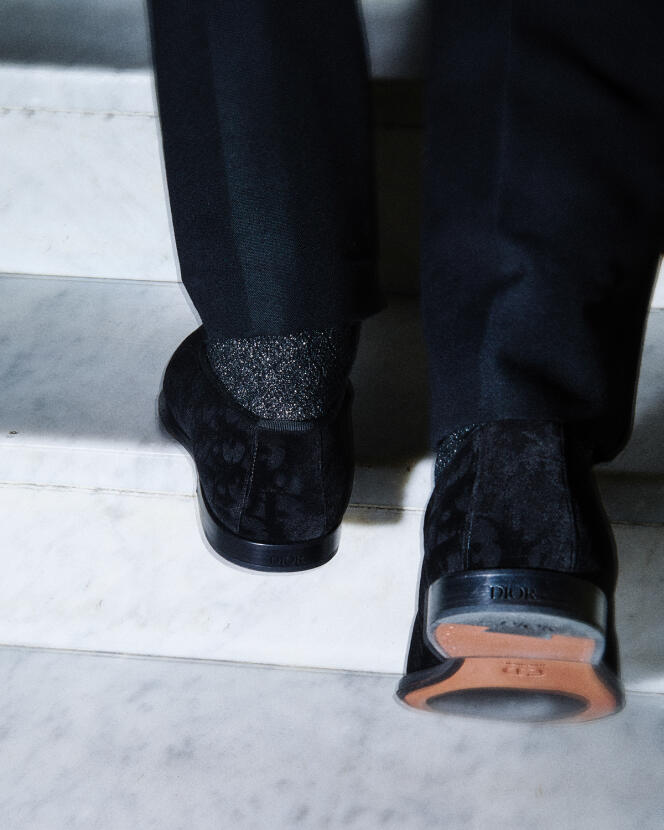 Timeless loafers in Dior Oblique velvet, €850, and virgin wool tuxedo pants, Dior Homme collection. Sequined socks by Calzedonia.