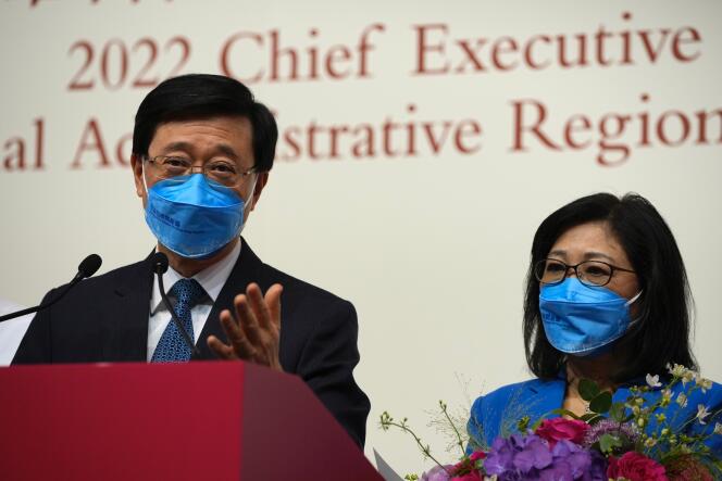 John Lee, former No. 2 official in Hong Kong and the only candidate for the city's top job, speaks next to his wife during a news conference after declaring his victory in the chief executive election of Hong Kong.