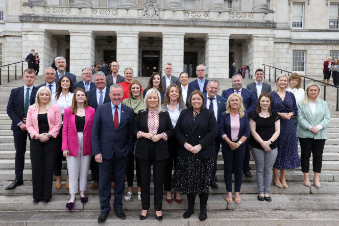 Sinn Fein's Michelle O'Neill, center, poses with her party's newly elected members of the legislative assembly outside Parliament Buildings at Stormont, Belfast, Northern Ireland, Monday, May 9, 2022. 