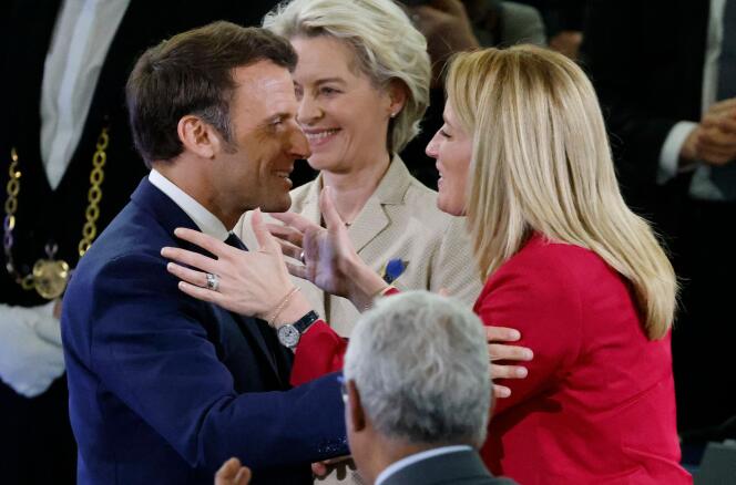 The President of the European Parliament, Roberta Metsola (R), embraces the French President, Emmanuel Macron (L), after her speech alongside the President of the European Commission, Ursula von der Leyen (C), at the Conference on the Future of Europe in Strasbourg on May 9, 2022.