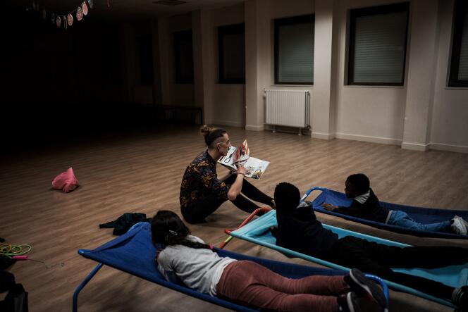 A teacher tells a story to homeless children before they sleep, at a school in Vaulx-en-Velin (in the Auvergne-Rhône-Alpes region of France), on January 10, 2019.