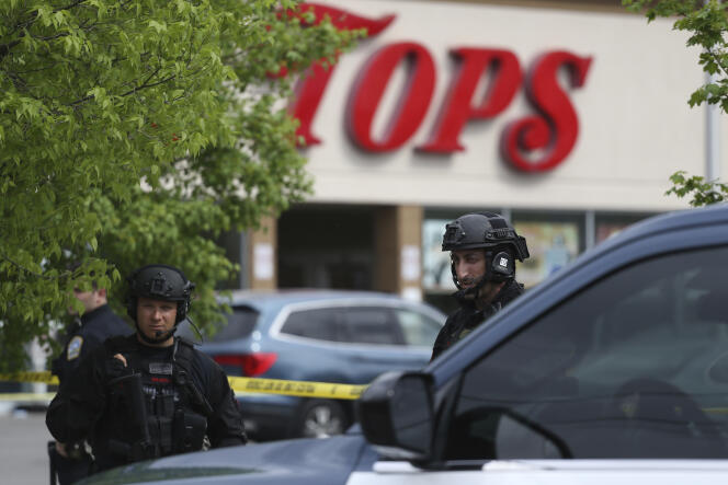 Police secure a perimeter after a shooting at a supermarket, Saturday, May 14, 2022, in Buffalo, N.Y. 
