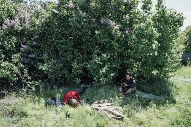 Ukrainian soldiers rest while waiting for their armored vehicle to be repaired, Kharkiv province, Ukraine, May 13, 2022.