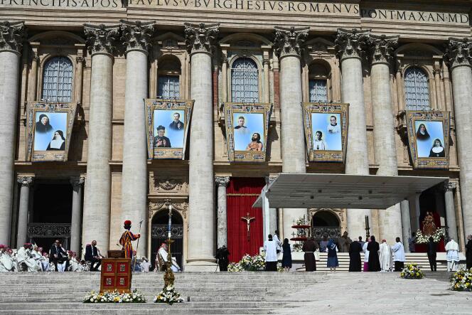 Portraits of ten beatified people hang in the facade of St. Peter's Basilica in Rome on Sunday 15 May.