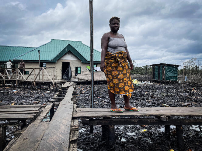 Praise Ase standing in the center of the fishing community of Bikumor-EkpoGbene, located an hour and a half by motorboat from the town of Warri in the Niger Delta on April 21, 2022.
