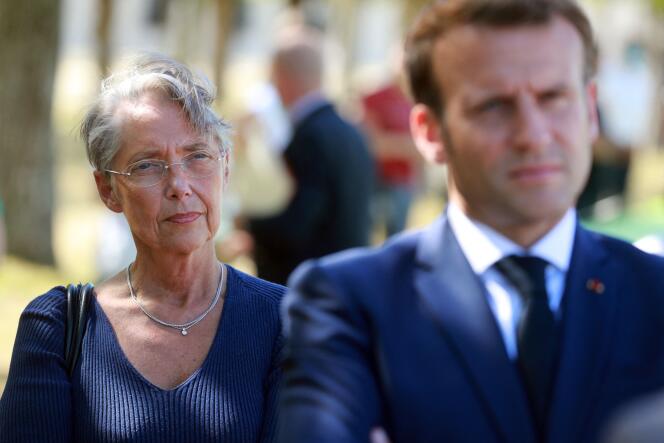 In this file photo taken on July 22, 2020, French Labour Minister Elisabeth Borne (L) and French President Emmanuel Macron are pictured at Chambord castle.