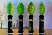 Photo : Des cheminées d’usine avec des feuilles vertes, symbole du verdissement de l’économie. 