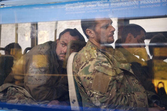 Ukrainian servicemen sit in a bus after they were evacuated from the besieged Mariupol's Azovstal steel plant, near a remand prison in Olyonivka, in territory under the government of the Donetsk People's Republic, eastern Ukraine, Tuesday, May 17, 2022. 