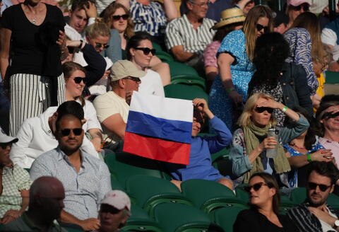 FILE - A spectator holding a Russian flag watches during the men's singles third round match between Russia's Daniil Medvedev and Croatia's Marin Cilic on day six of the Wimbledon Tennis Championships in London, Saturday July 3, 2021. The ATP men’s professional tennis tour will not award ranking points for Wimbledon this year because of the All England Club’s ban on players from Russia and Belarus over the invasion of Ukraine. The ATP announced its decision Friday night, May 20, 2022, two days before the start of the French Open — and a little more than a month before play begins at Wimbledon on June 27. It is a highly unusual and significant rebuke of the oldest Grand Slam tournament. (AP Photo/Alberto Pezzali, File)