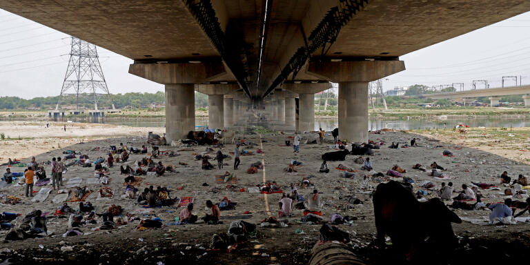 NEW DELHI, INDIA - MAY 10: People take rest under a bridge at the Yamuna River bed on a hot summer day in New Delhi, India on May 10, 2022. The Indian Meteorological Department (IMD) has warned of a fresh heatwave spell in Delhi from Wednesday, when temperatures are expected to soar to 44 degrees Celsius. The heatwave is expected to last till' May 15. Amarjeet Kumar Singh / Anadolu Agency (Photo by Amarjeet Kumar Singh / ANADOLU AGENCY / Anadolu Agency via AFP)