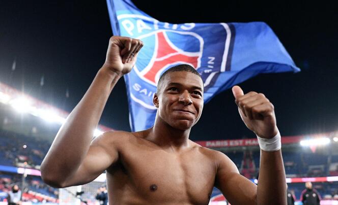 In this file photograph taken on October 7, 2018, Paris Saint-Germain's French forward Kylian Mbappe celebrates with supporters after scoring four goals and winning the French L1 football match between Paris Saint-Germain (PSG) and Olympique de Lyon (OL) at the Parc des Princes stadium in Paris.
