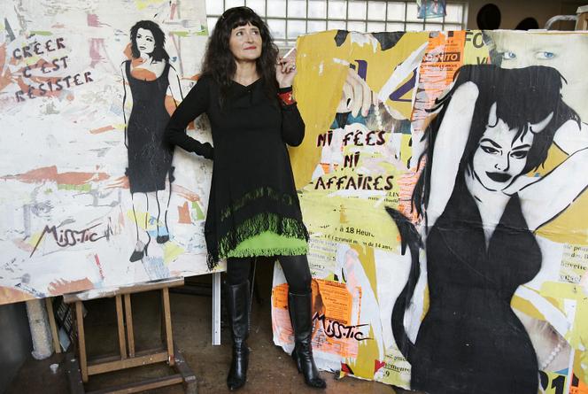 La artista Miss Tic posa junto a una de sus obras en su estudio, el 31 de enero de 2006 en París.  Esta figura del street art, cuyas plantillas adornan las paredes de la capital desde hace veinte años, publicó un libro, “Miss Tic en París”, el pasado mes de noviembre.  AFP FOTO BERTRAND GUAY (Foto por BERTRAND GUAY / AFP)