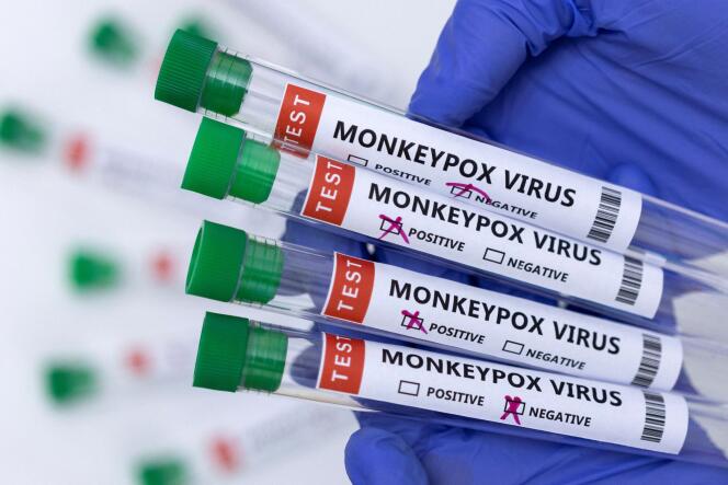Test tubes labeled 'monkey pox virus positive and negative' are seen in this illustration taken on May 23, 2022. 