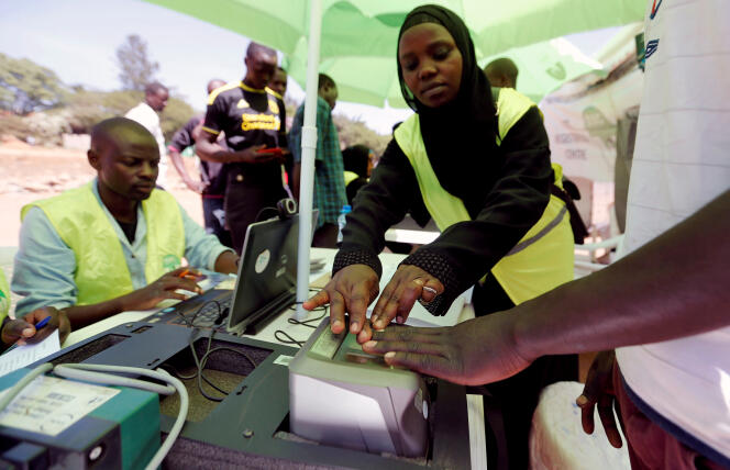 Kenyan electoral commission officials take down a man's fingerprints during a voter registration operation in the capital city of Nairobi in January 2017.