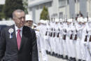 Turkish President Recep Tayyip Erdogan inspects a military honour guard during a ceremony marking the docking of a submarine, in Kocaeli, Turkey, Monday, May 23, 2022. Erdogan, whose country has objected to Sweden and Finland joining NATO, called on Stockholm on Monday to take "concrete steps" that would alleviate Turkey's security concerns. (Turkish Presidency via AP Photo)