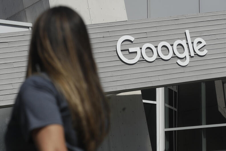 FILE - A woman walks below a Google sign on the campus in Mountain View, Calif., on Sept. 24, 2019. More than 40 Democratic members of Congress are asking Google to stop what they see as the unnecessary collection and retention of peoples' location data. They're concerned it could be used to identify women seeking abortions. The group of Democrats on Tuesday, May 24, 2022 sent a letter to the CEO of Google's parent company saying that if abortion were to become illegal in the U.S., the cellphone location data collected and retained by the company could be used by far-right extremists looking to crack down on women seeking reproductive health care. (AP Photo/Jeff Chiu, File)