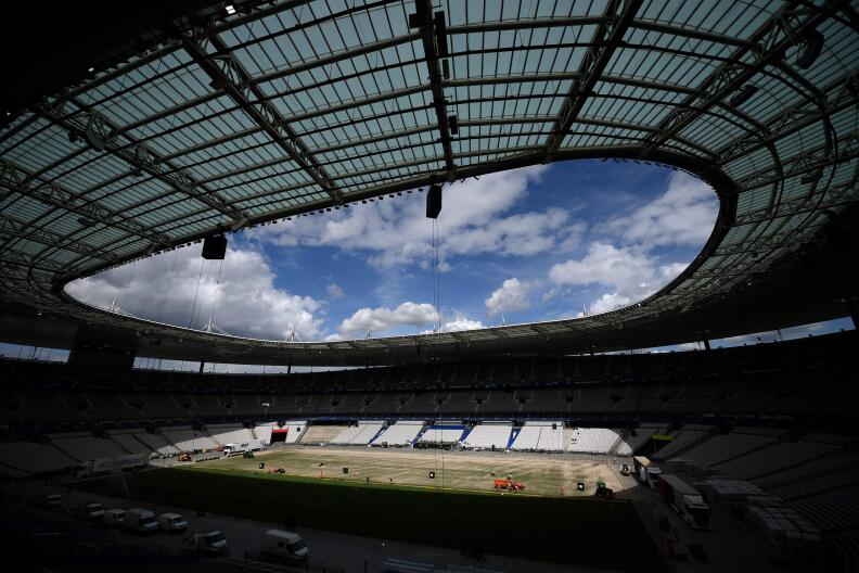Stade de France staff install a new hybrid pitch at the Stade de France, in Saint-Denis, outside Paris, on May 24, 2022. Within 48 hours, a new pitch grown outside of Barcelona was installed at the Stade de France for the Champions League football final between Real Madrid and Liverpool scheduled to take place on May 28, 2022. (Photo by FRANCK FIFE / AFP)