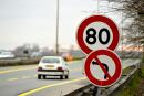 A car drives past a road sign indicating a speed limit of 80 km/h on a road near Bordeaux, southwestern France. - The French government announces on January 9, 2018 a speed restrictiom from 90km/h to 80km/h on some 400 000 km of secondary roads in the country, in order to reduce the number of fatal accidents each year. (Photo by Nicolas TUCAT / AFP)