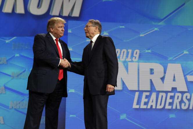 President Donald Trump shakes hands with NRA executive vice president and CEO Wayne LaPierre, has he arrives to speak to the annual meeting of the National Rifle Association, April 26, 2019, in Indianapolis. 