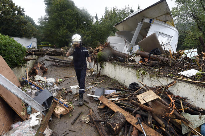 A firefighter walks in the middle of the debris carried by the flood in Lamalou-les-Bains, September 18, 2014.