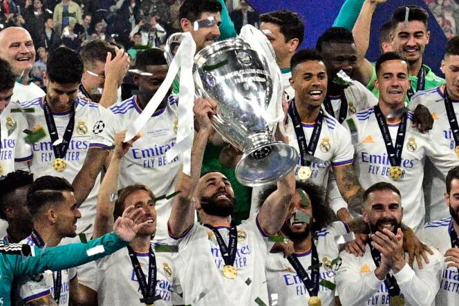 Real Madrid captain Karim Benzema, surrounded by his teammates, lifts the UEFA Champions League trophy on Saturday May 28 at the Stade de France in Saint-Denis (Seine-Saint-Denis).