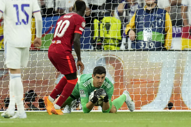 Real Madrid's goalkeeper Thibaut Courtois makes a save in front of Liverpool's Sadio Mane during the Champions League final, Saturday, May 28, 2022.
