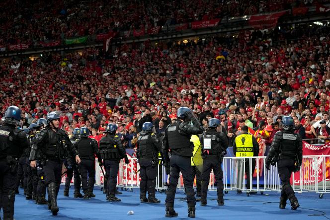 Police face British supporters during the Champions League final between Liverpool and Real Madrid at the Stade de France on May 28, 2022.