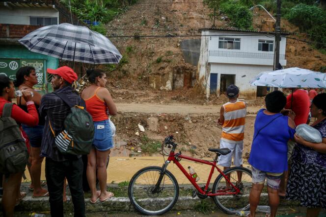 Residents look at a landslide area at the community Jardim Monte Verde, Ibura neighbourhood, in Recife, Pernambuco State, Brazil, on May 29, 2022.  