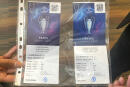 A real, left, and a fake ticket for the Champions League final are displayed at a press conference in Paris Monday, May 30, 2022 following a meeting on security after incidents during the Champions League final at the Stade France stadium. French authorities have defended police for indiscriminately firing tear gas and pepper spray at Liverpool supporters at the Champions League final while blaming industrial levels of fraud that saw 30,000 to 40,000 people try to enter the Stade de France with fake tickets or none at all. (AP Photo/Rob Harris)