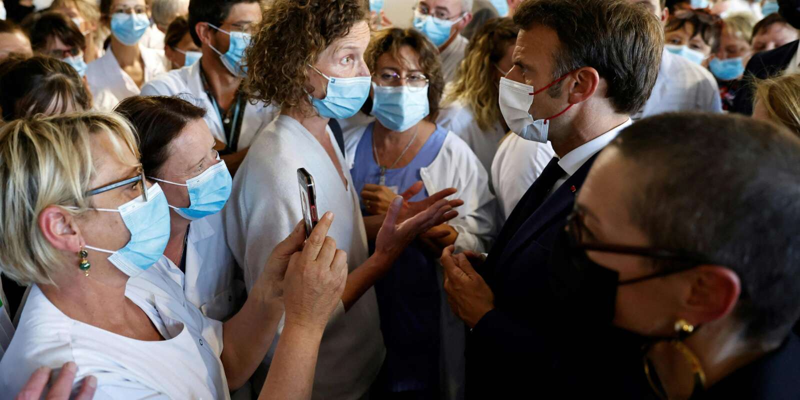 Emmanuel Macron échange avec des personnels soignants lors de sa visite du centre hospitalier de Cherbourg, le 31 mai 2022. 