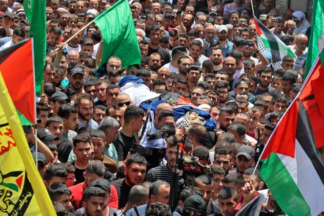 Palestinians carry the body of a young Palestinian man killed in clashes with the Israeli army, near Jenin in the occupied West Bank on June 2, 2022.