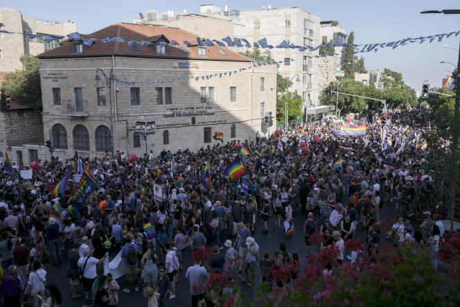 Participants march in the annual Pride Parade in Jerusalem, Thursday, June 2, 2022. Thousands of people marched in the parade through the streets of Jerusalem under heavy security over fears of extremism. (AP Photo/Ariel Schalit)