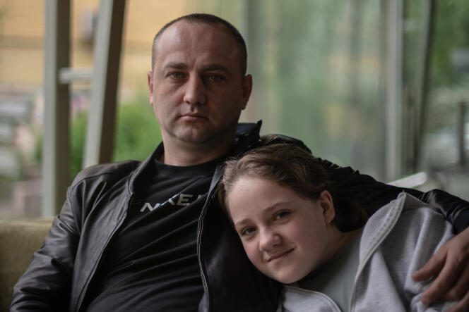 Dmytro Paraschinets, regional councillor of Kherson Oblast and former policeman, with his daughter, in Kyiv, May 14, 2022.