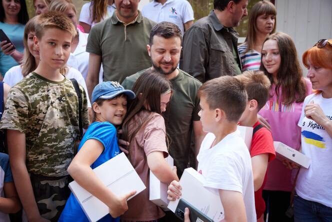 A handout picture taken and released by the Ukrainian presidential press service on June 5, 2022, showing Ukrainian President Volodymyr Zelensky posing with people for a picture as he visits a sanatorium where Ukrainians who had been forced to leave their homes after the Russian invasion were housed during a working trip to the Zaporizhzhia region. 