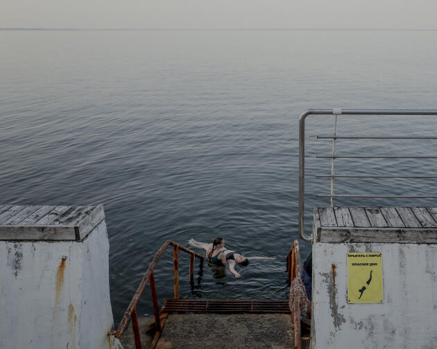 Young Ukrainian women swim in the Black Sea, despite the presence of mines, in Odesa, Ukraine, May 31, 2022.