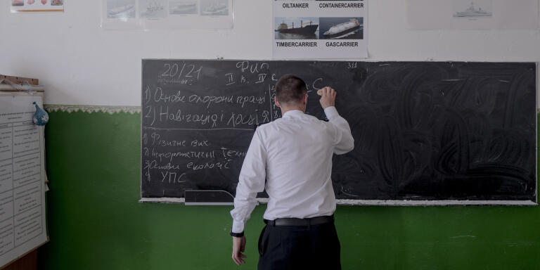A young student in uniform in a classroom of the Maritime Academy founded in 1898, in Odessa, Ukraine, June 3, 2022.