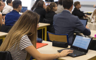 In this photograph taken on September 26, 2017, high school students uses a computer at the vocational school in Bischwiller, eastern France. - Since the beginning of the school year in eastern France some 31,000 high school pupils have replaced their traditional textbooks by computers and tablets , a move popular with students but opinion is divided among teachers and parents. (Photo by PATRICK HERTZOG / AFP)