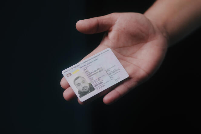 Aladdin Ayyad, an Algerian student and refugee from the conflict in Ukraine, shows his Ukrainian residency card, in Paris, June 2, 2022.
