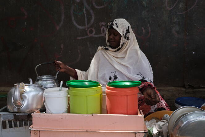 Al-Toma serving her tea at Sherwani crossing in Khartoum, June 8, 2022.