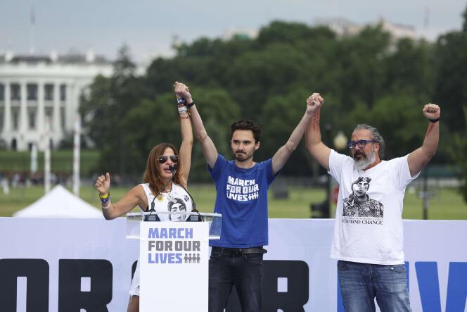 Gun control activist David Hogg, Manuel and Patricia Oliver, parents of Parkland shooting victim Joaquin Oliver, cheer on stage during March for Our Lives rally on the National Mall June 11, 2022 in Washington.